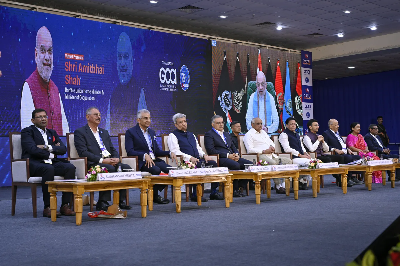 Dignitaries on the dais at GATE 2025 with the Union Home Minister addressing virtually